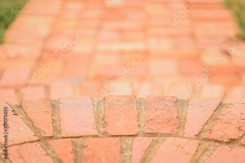 Red brick footpath close up. Texture and pattern of bricks in a semi-circle format