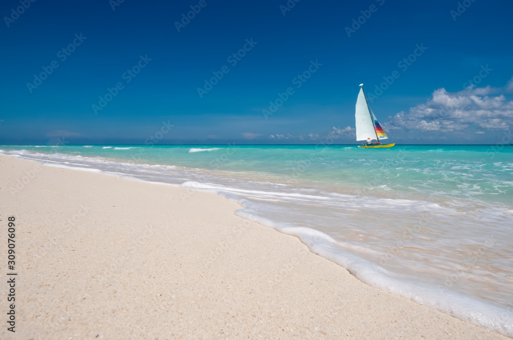 Beautiful view close up beach Caribbean sea Escape from Riviera Maya Mexico. Hobie-cat sailing in background