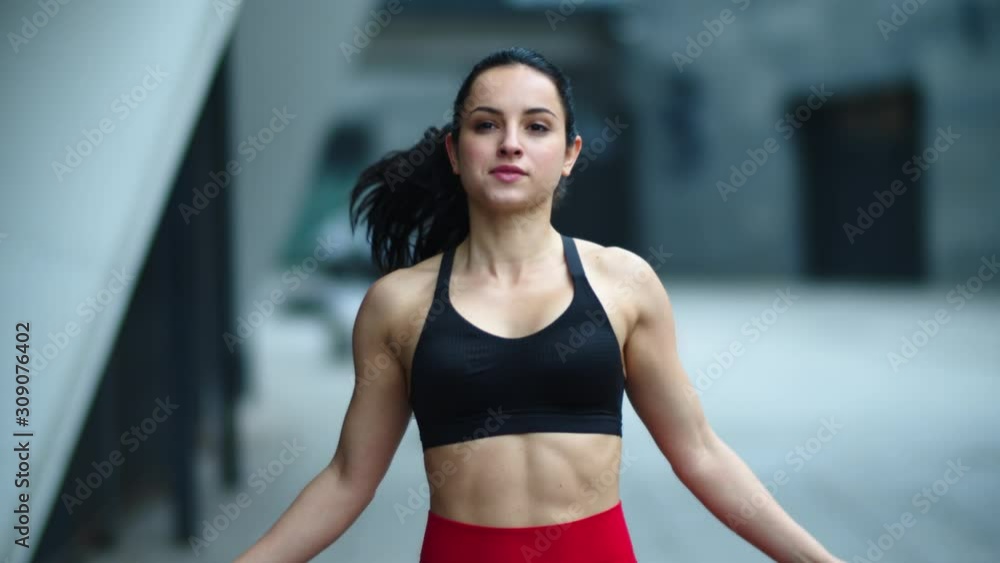 Fit woman jumping with skipping rope outdoor. Athlete woman practicing jumping Fit woman jumping with skipping rope outdoor. Athlete woman practicing jumping