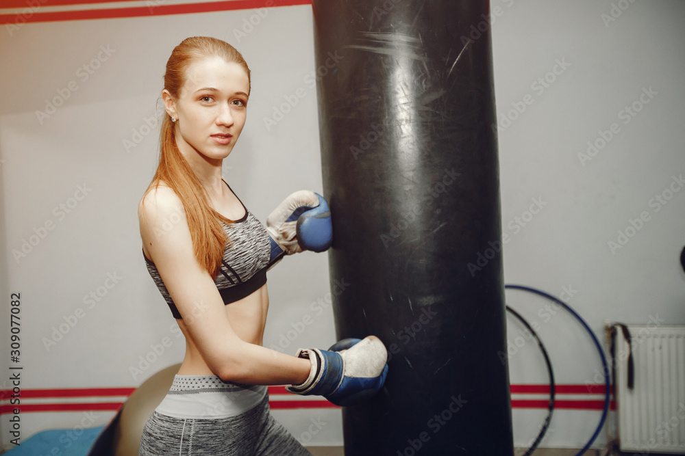Girl in a gym. Woman training. Lady in a sportswear