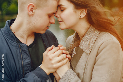 Lovely couple in a summer park. Boy with his girlfriend. Couple near water