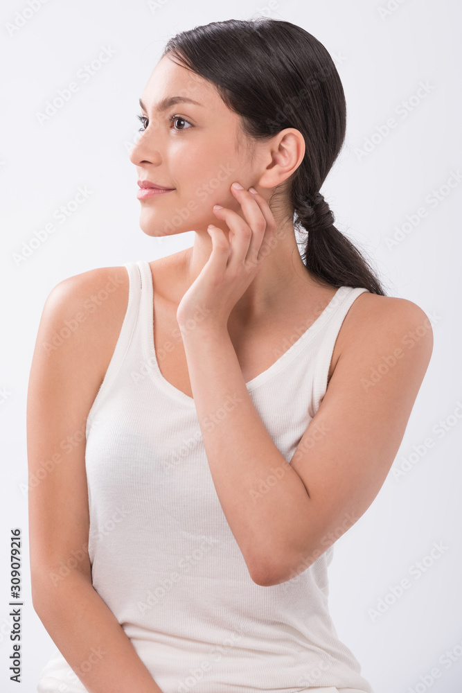 beautiful young woman with clean fresh skin touch own face . facial treatment . cosmetology , beauty and spa . beautiful young woman with clean fresh skin touch own face . facial treatment . cosmetology , beauty and spa .