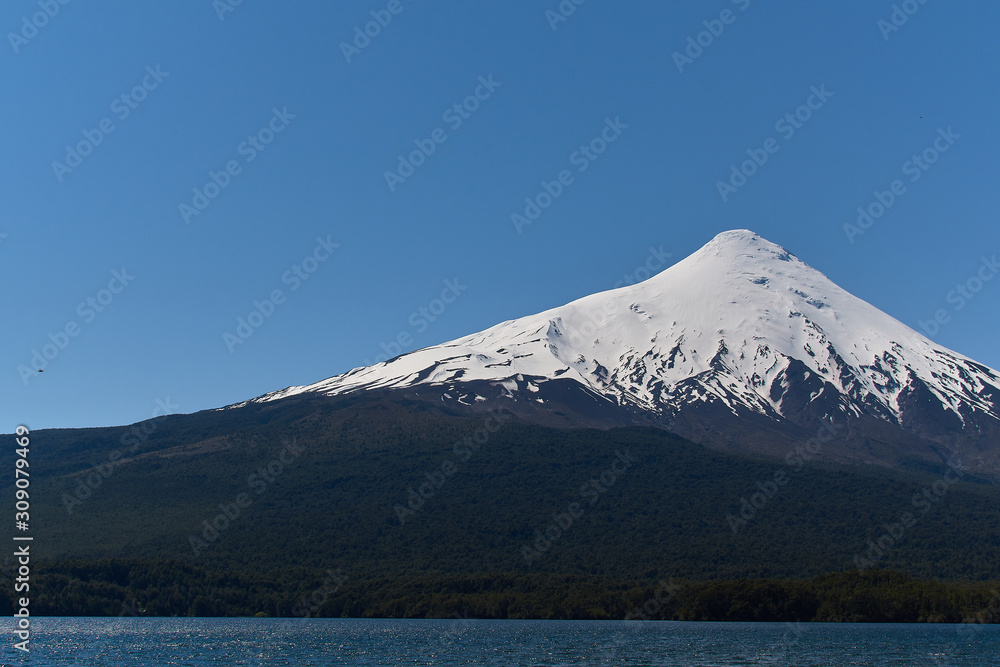 The Osorno volcano seen from Ensenada near Puerto Varas in South Chile. Nature and blue sky.