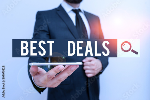 Handwriting text Best Deals. Conceptual photo very successful transaction or business agreement or a bargain Male human wear formal work suit hold smart hi tech smartphone use one hand