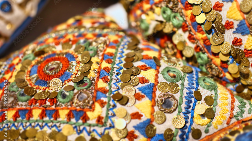 close up on a home decor cushion with Indian or middle eastern colors and textiles