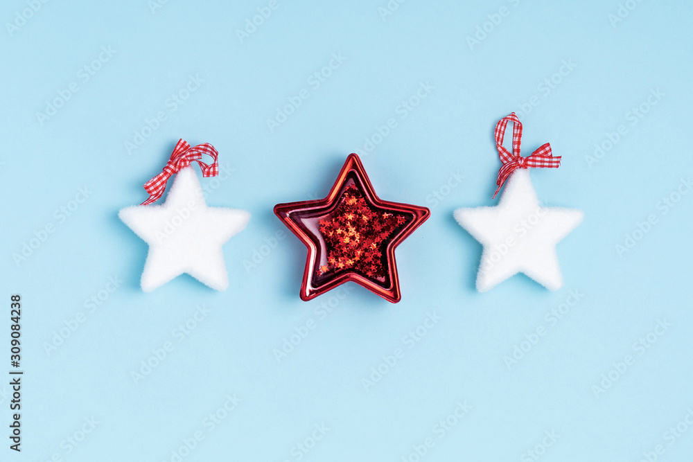 New Year and Christmas composition from stars on pastel blue background. Top view, flat lay, copy space New Year and Christmas composition from stars on pastel blue background. Top view, flat lay, copy space
