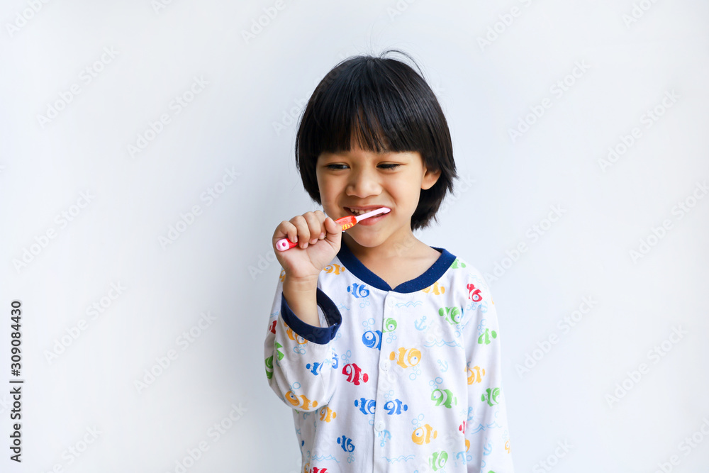Little boy brushing his teeth Gray background Little boy brushing his teeth Gray background