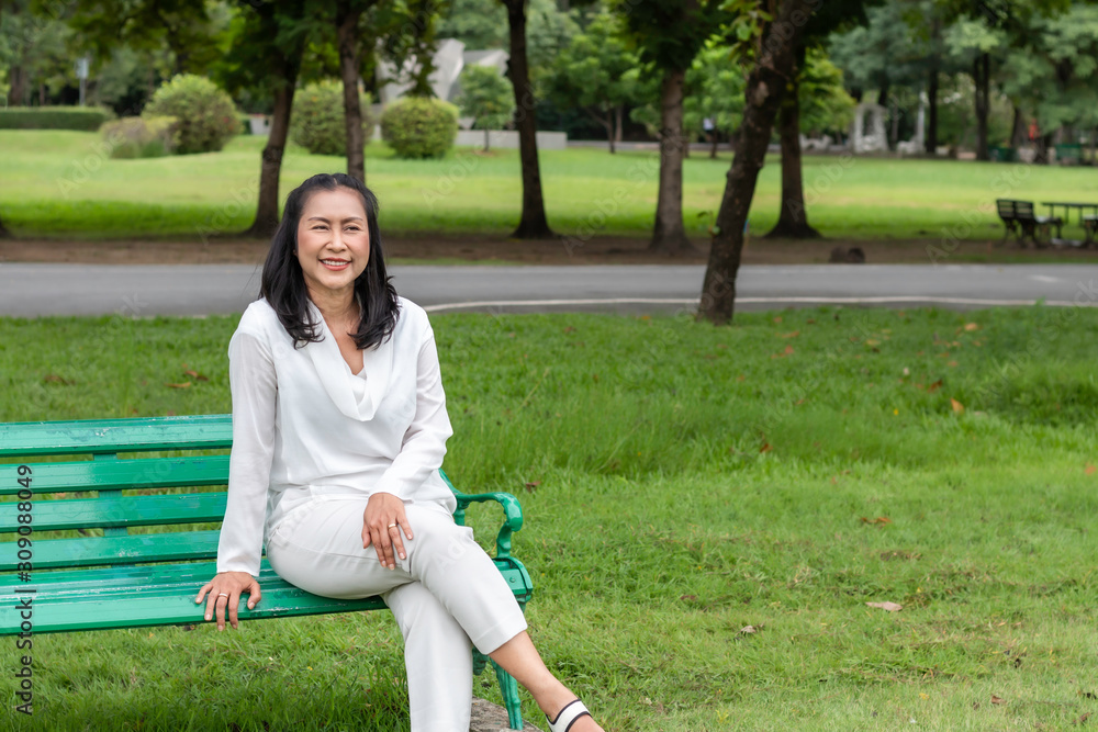 Asian beautiful portrait of senior woman thinking and relaxing at the park. Asian beautiful portrait of senior woman thinking and relaxing at the park.