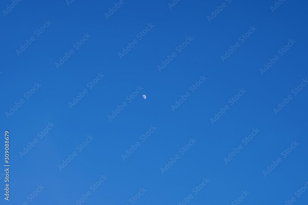 The Half Moon on daylight on blue sky nature background. long-distance photo The Half Moon on daylight on blue sky nature background. long-distance photo