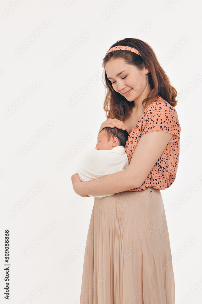 the concept of a healthy lifestyle, the protection of children, shopping - baby in the arms of the mother. Woman holding a child. Isolated on white background. Copy space the concept of a healthy lifestyle, the protection of children, shopping - baby in the arms of the mother. Woman holding a child. Isolated on white background. Copy space