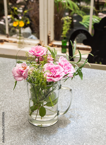 Beautiful flower arrangement in glass vase on the table