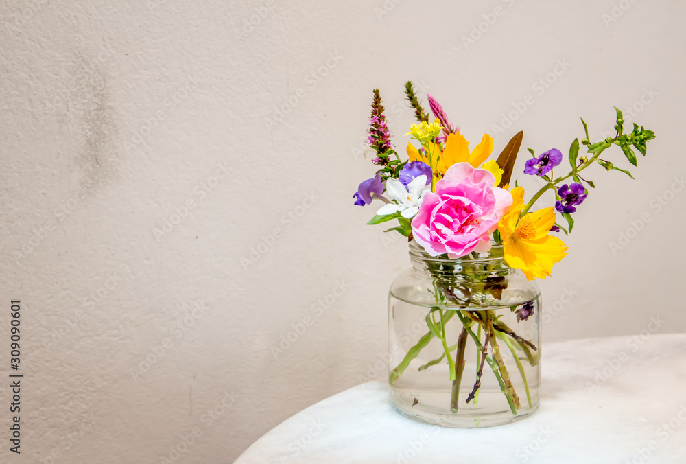Beautiful flower arrangement in glass vase on the table Beautiful flower arrangement in glass vase on the table