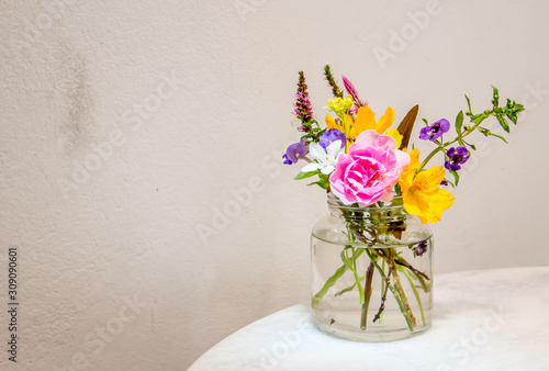 Fototapeta Naklejka Na Ścianę i Meble -  Beautiful flower arrangement in glass vase on the table