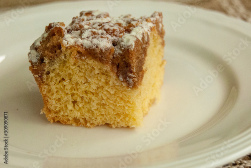 Single piece of coffee crumb cake served on a white plate