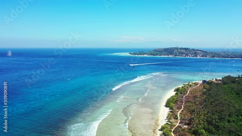 Aerial panorama, boat sailing between the tropical islands on a sunny day photo