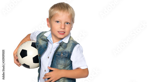 Little boy is playing with a soccer ball. © lotosfoto