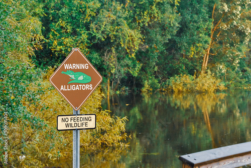 Alligator warning sign posted near a lake in Florida