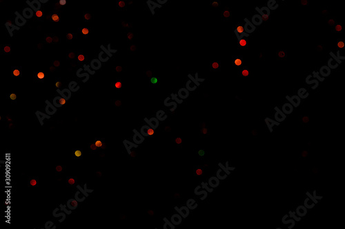 Red glitter bokeh lights on black background, unfocused. Holiday time. overlay layer