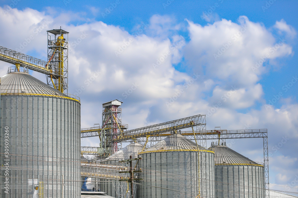 Agricultural Silos ,Industrial silos Storage and drying of grains with Blue Sky and White Clouds