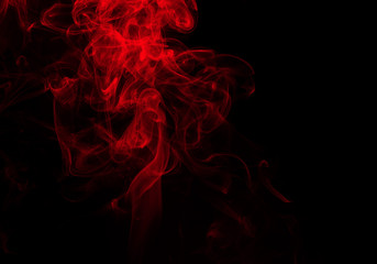 Fluffy puffs of red smoke and fog on black background, fire design and darkness concept