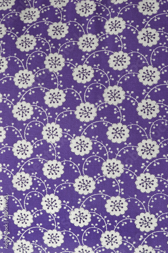 violet beautiful Asian style background with small white flowers, textile texture background decorated with white print pattern in purple color, seamless flower pattern design on violet background