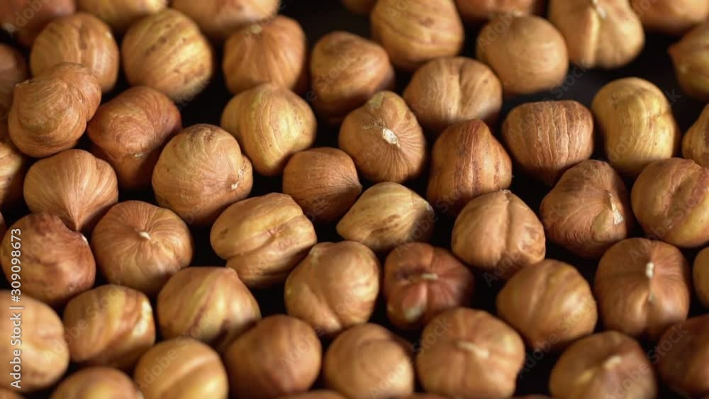 Нazelnut close up. product rich in minerals and vitamins. Нazelnut turns in a shot. Hazelnut kernels rotating. Hazelnut close up lies under beams of the sun. Macro 4K Нazelnut close up. product rich in minerals and vitamins. Нazelnut turns in a shot. Hazelnut kernels rotating. Hazelnut close up lies under beams of the sun. Macro 4K