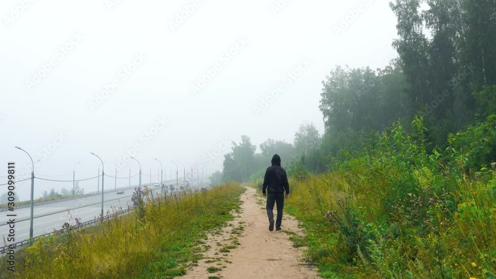 The man goes into a thick fog The man goes into a thick fog