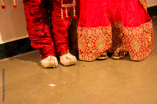 Traditional indian wedding ceremony : Groom puts on  wedding shoes photo