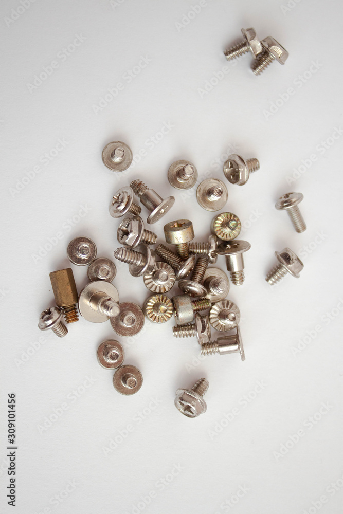 Small iron screws closeup beautifully scattered nuts Small iron screws closeup beautifully scattered nuts