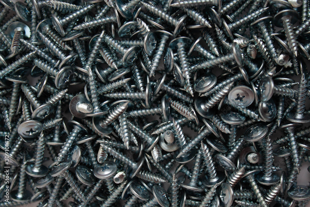 Small iron screws closeup beautifully scattered nuts Small iron screws closeup beautifully scattered nuts