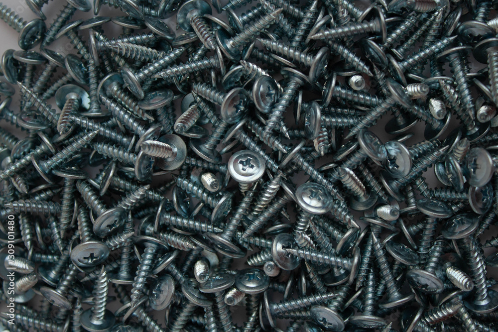 Small iron screws closeup beautifully scattered nuts Small iron screws closeup beautifully scattered nuts