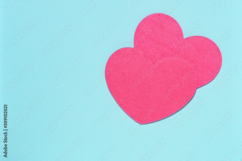 Two pink hearts on a blue background close-up. Greeting card with copy space. Flat lay minimal concept. Valentine's Day background