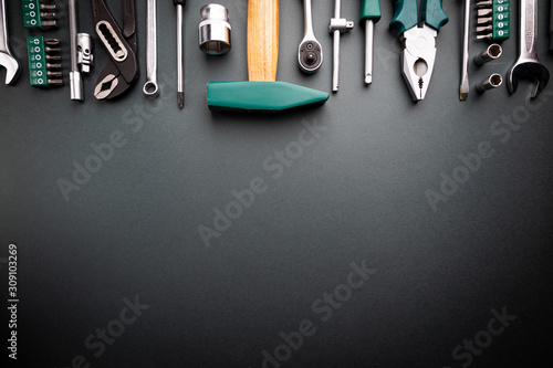 Set of tools over black background, top view with space for text photo