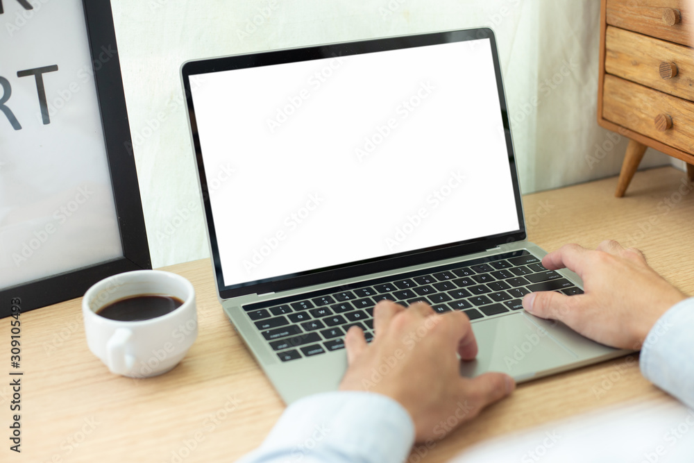 mockup image blank screen computer with blank white background for advertising text,hand man using laptop contact business search information on desk at home office.marketing and creative design mockup image blank screen computer with blank white background for advertising text,hand man using laptop contact business search information on desk at home office.marketing and creative design