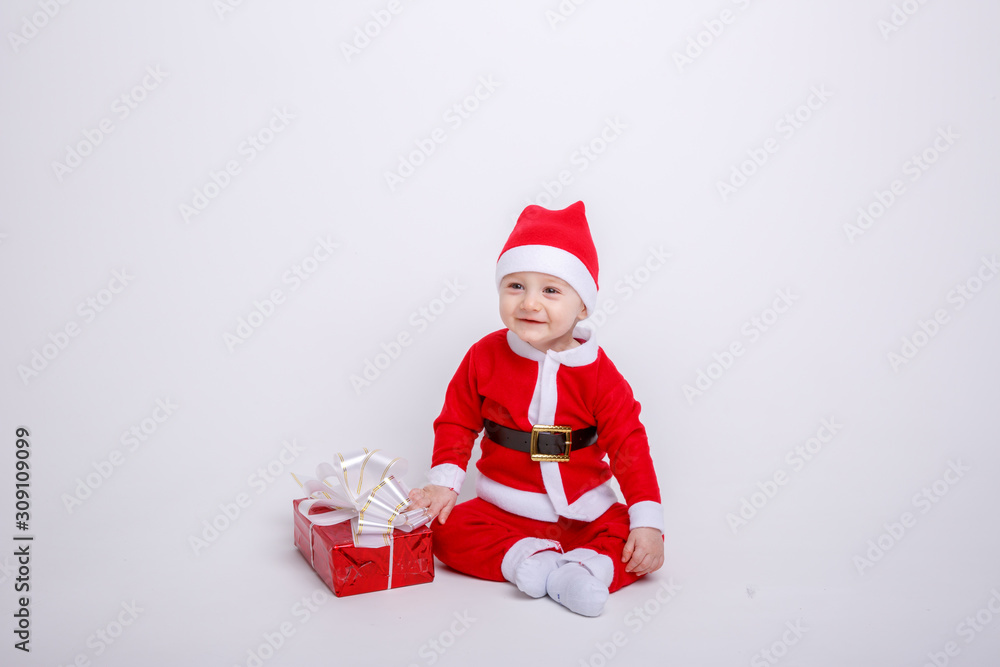 a baby in a Santa Claus costume on a white background