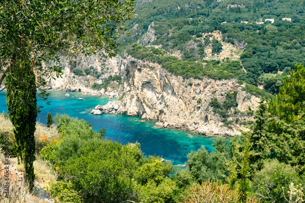 Sea rocks along Ionian sea coast in Paleokastritsa resort in June. Corfu Island, Greece