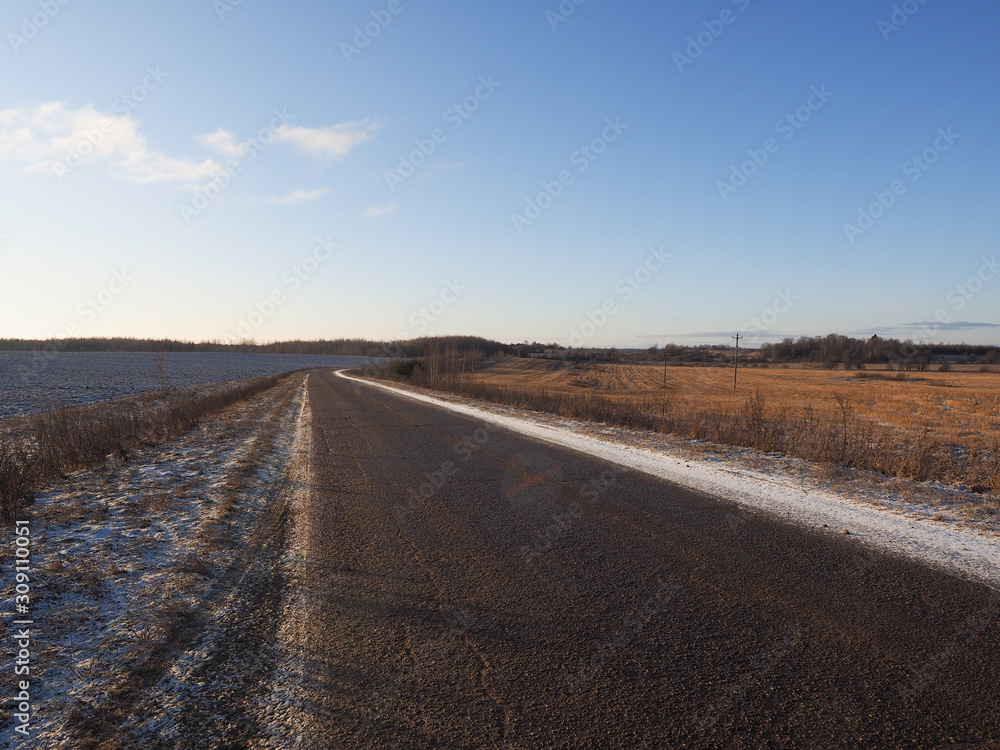 Road and autumn rural landscape. First frost, snow Road and autumn rural landscape. First frost, snow
