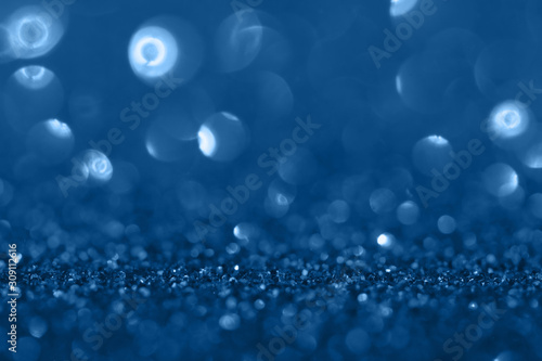 Blue festive background with sparkles in the bokeh. The concept of the celebration, the day of St. Valentine, New Year, birthdays, ceremonies, events, etc.