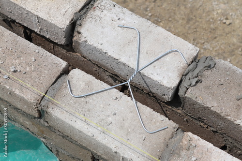 Wall ties, sometimes called ‘brick ties’, are used in buildings with cavity walls. They are used to join the two leaves of a cavity wall together, allowing the two parts to act as a one strong unit. photo