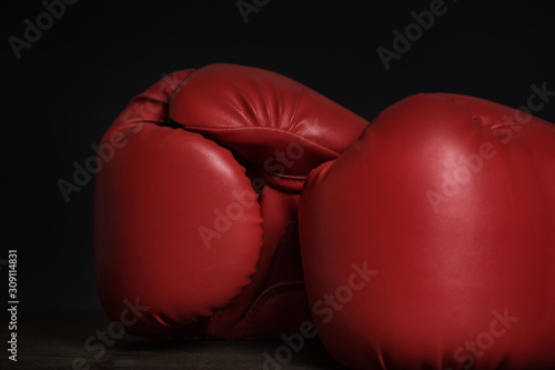 Pair of red boxing gloves on a black background. Close up © somemeans