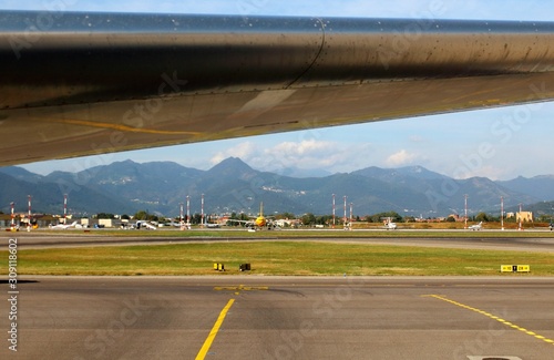 evocative image of an airplane's wing in the rest area with the mountains in the background