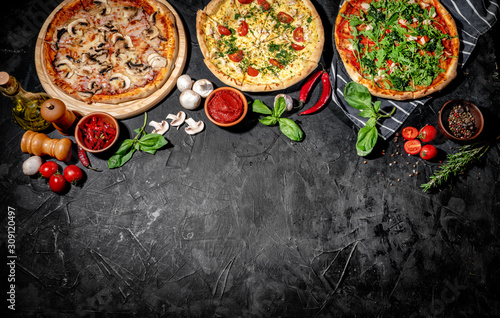 Traditional Italian pizza, vegetables, ingredients on a dark background. Top ...