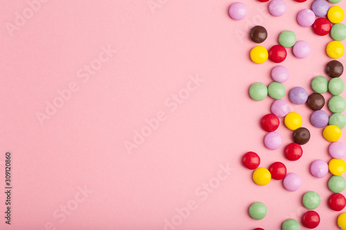 pink background with candy little multicolored © Elena