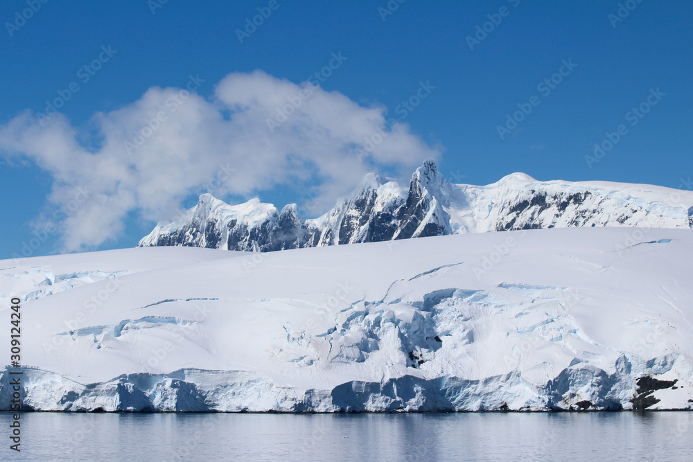 Snow-capped mountains on an island along the coasts of the Antarctic Peninsula, Palmer Archipelago, Antarctica