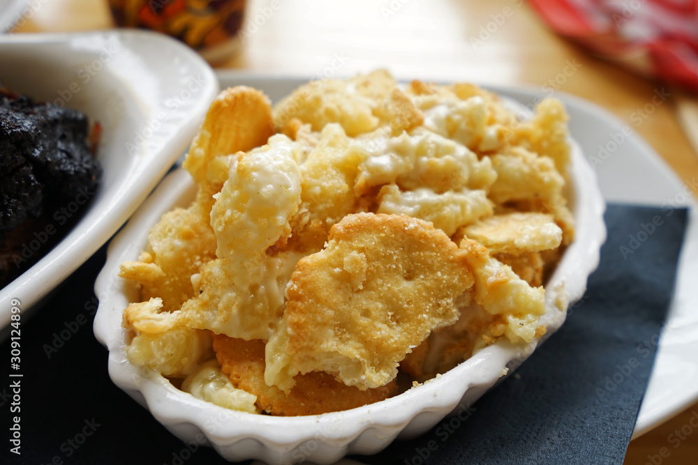 Close up macaroni and cheese served with crispy crackers