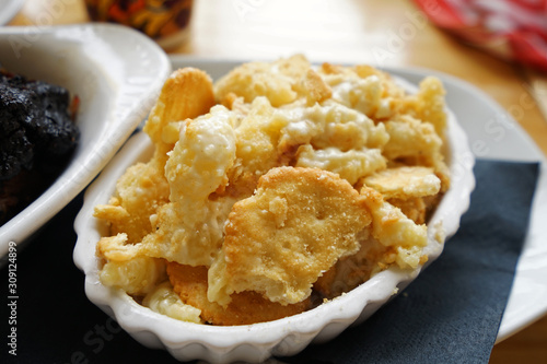 Close up macaroni and cheese served with crispy crackers