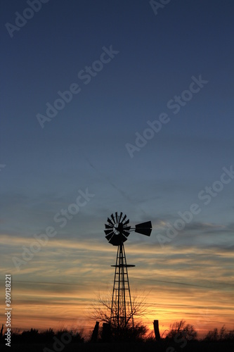 windmill at sunset with clouds.
