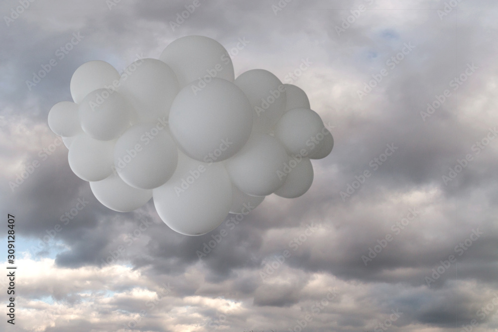 White cloud of helium balloons against a cloudy sky. White cloud of helium balloons against a cloudy sky.