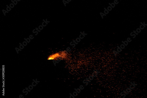 Corn being cooked on coal near beach with some fire spark . A corn roaster sparkling fire in the shores of Marina Beach, Chennai, India on night