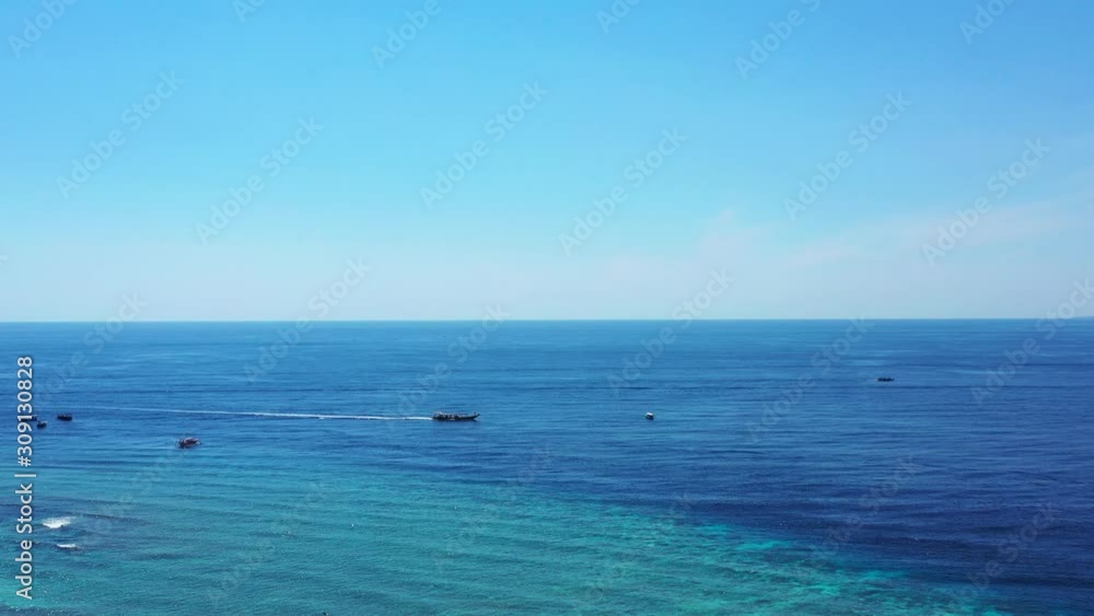 Bahamas Beach Showing A Ship Sailing Horizontally Across The Blue Ocean - Wide Shot Bahamas Beach Showing A Ship Sailing Horizontally Across The Blue Ocean - Wide Shot